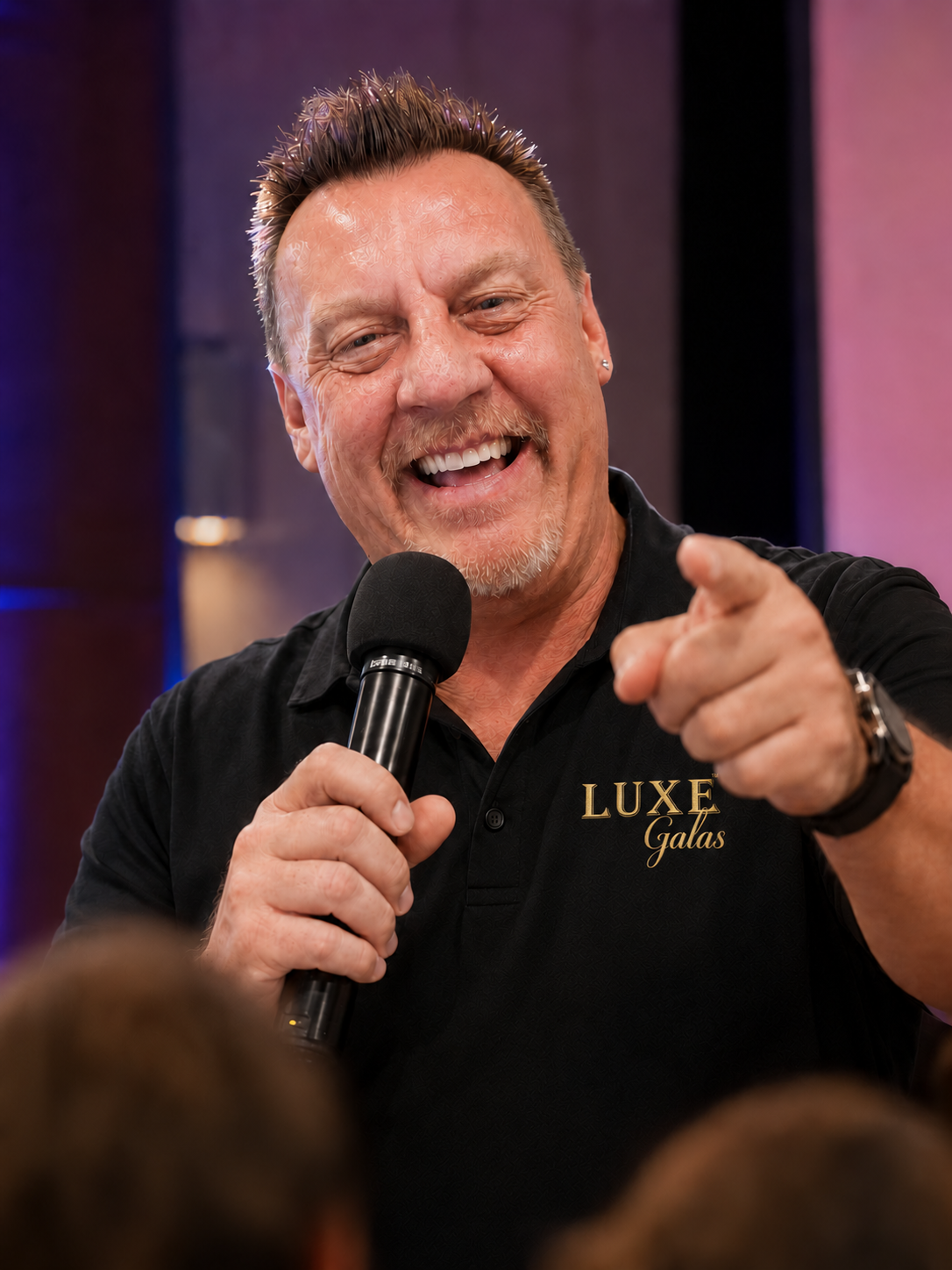 Luxe Galas host engaging the audience with a microphone