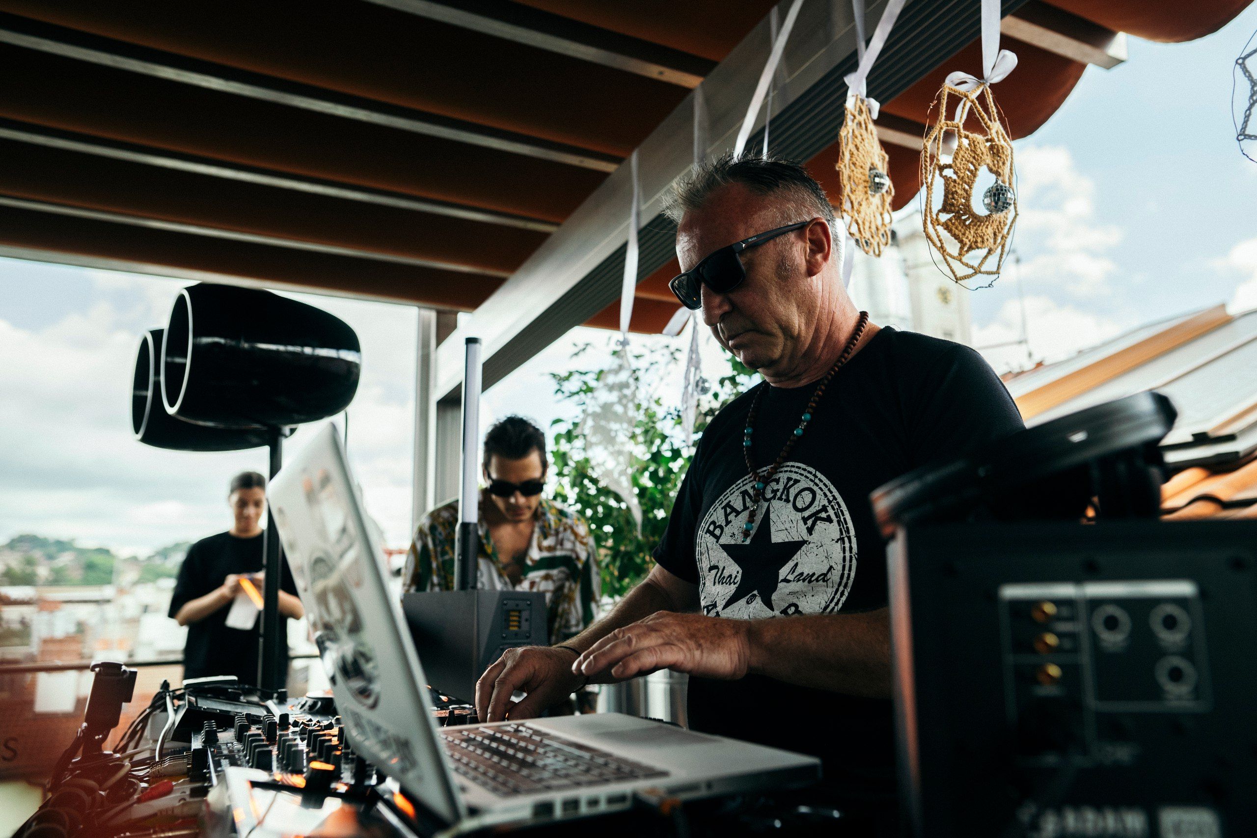 DJ mixing music at an outdoor evening event